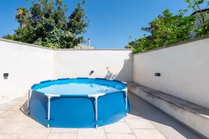 a hot tub on a balcony with a wall at Al Vecchio Cinema Martano in Martano