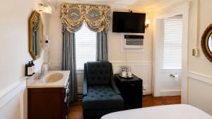 a bathroom with a sink and a chair in a room at Bellevue House in Newport +46 photos