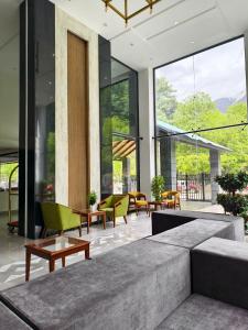 a living room with a couch and chairs and windows at Luxus Naran in Naran