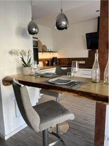 a kitchen with a large wooden table and chairs at Moselmoni in Bullay +13 photos