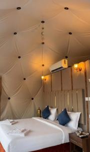 a bedroom with two beds in a tent at WADI RUM NASA lUXURY BUBBLE in Wadi Rum