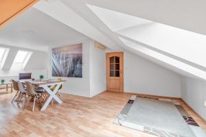 a dining room with a table and chairs in a attic at Apartmány Nerudova in Vítkovice