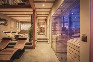 a lobby with benches and tables in a building at Romantik Hotel Bären Dürrenroth in Dürrenroth
