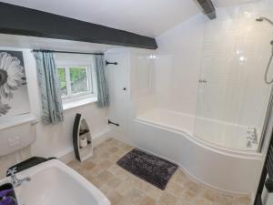 a white bathroom with a tub and a sink at The LA'AL Cragg in Kirkby Stephen +21 photos