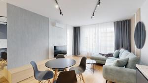 a living room with a couch and a table and chairs at Candy 3 in Trnava