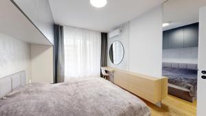 a bedroom with a large bed and a mirror at Candy 3 in Trnava