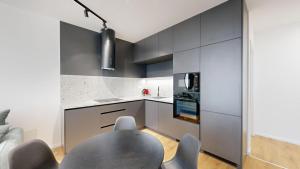 a kitchen with a table and some chairs at Candy 3 in Trnava