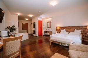 a large bedroom with two beds and a dining room at Relax- & Wanderhotel Poppengut in Hinterstoder +105 photos