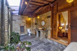 a bathroom with a toilet and a sink at Uma Sunset Villa in Ubud +59 photos