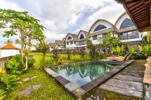 an exterior view of a villa with a swimming pool at Uma Sunset Villa in Ubud
