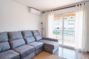 a living room with a couch and a large window at Olot céntrico, La Garrotxa, Petfriendly in Olot