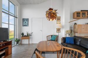 a living room with a table and a couch at LF15113-Farso-Strandvejen-12-B in Farsø