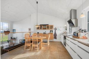 a kitchen and dining room with a table and chairs at LF15113-Farso-Strandvejen-12-B in Farsø