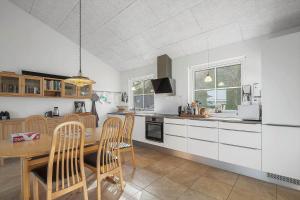 a kitchen with a table and chairs in a room at LF15113-Farso-Strandvejen-12-B in Farsø +13 photos