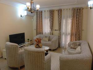 a living room with couches and a flat screen tv at Amidez Apparts in Zalom