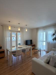 a living room with a table and a couch at Apartments Annette - studio and two bedroom apartment with parking in Dubrovnik