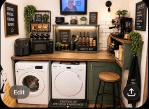 a kitchen with a counter with a washer and dryer at Honeydon in Eaton Socon