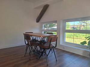 a dining room with a table and four chairs at Stable for two in Hégenheim