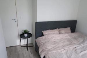 a bedroom with a bed and a side table at Modern Apartment Bergen Centrum in Bergen