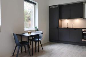 a kitchen with a table and chairs in a room at Modern Apartment Bergen Centrum in Bergen