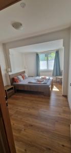 a bedroom with a bed and a wooden floor at Pod Vinicí in Mikulov