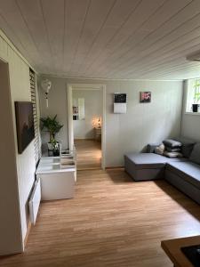 a living room with a couch and a table at Room in a shared apartment in Trondheim