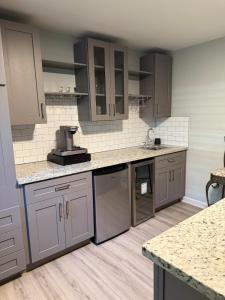 a kitchen with gray cabinets and a counter top at Cozy ATL Suite with Kitchenette in Atlanta