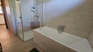 a bathroom with a tub and a glass shower at VárLak in Várbalog +50 photos