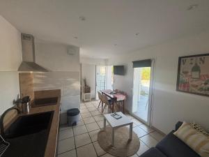 a kitchen and living room with a couch and a table at Apartment with mountain view in Espelette +10 photos