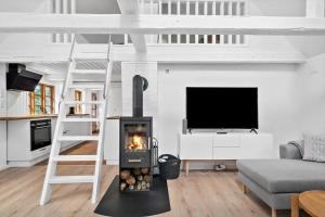 a loft bed with a fireplace in a living room at LF11124-Struer-Vesterkaervej-24 in Struer