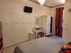 a bedroom with a bed and a tv on the wall at DolceMorfeo in Olbia