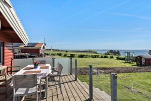 a wooden deck with a table and chairs on a house at LF544-Hurup-Thy-Skraningen-3 in Doverodde