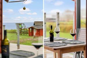 a table with two glasses of wine and a window at LF544-Hurup-Thy-Skraningen-3 in Doverodde