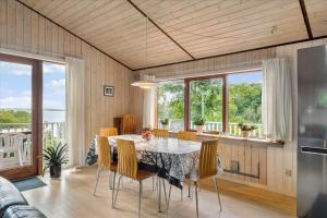 a kitchen and dining room with a table and chairs at LF483-Snedsted-Bjergvej-8 in Snedsted