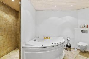 a white bathroom with a tub and a toilet at LF483-Snedsted-Bjergvej-8 in Snedsted +24 photos