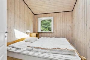 a large white bed in a room with a window at LF483-Snedsted-Bjergvej-8 in Snedsted