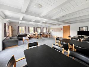 a room with tables and chairs and a living room at 0397-Romo-Engvej-40 in Høm
