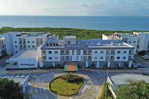 an aerial view of a hotel with the ocean in the background at Residence Inn by Marriott Cancun Hotel Zone in Cancún