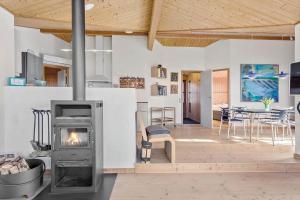 a living room with a wood stove in a room at LF241-Snedsted-Kongens-Borer-10 in Snedsted