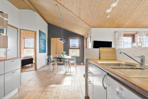 a kitchen with a table and a dining room at LF241-Snedsted-Kongens-Borer-10 in Snedsted