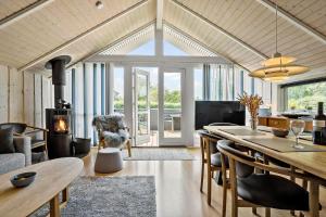 a kitchen and living room with a table and chairs at LF328-Vestervig-Gunhildsvej-28 in Vestervig