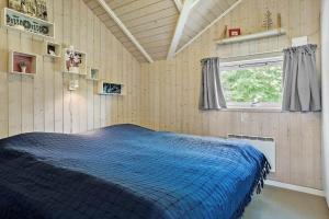 a bedroom with a blue bed in a room at LF328-Vestervig-Gunhildsvej-28 in Vestervig