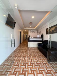 a lobby with a couch and a stage in a room at OR Stay Semporna in Semporna