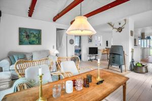 a living room with a table and a couch at 10040-Rorvig-Lyngvaenget-10 in Rørvig +20 photos