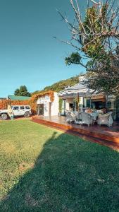 a house with a patio and a yard at Buff and Fellow by the Bay in Great Brak River