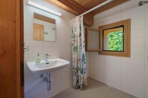 a bathroom with a sink and a window at Chalet des Cheneaux in Bruson +11 photos