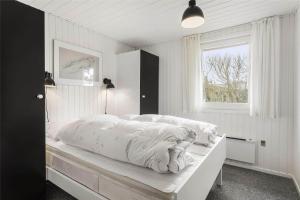 a bedroom with a large white bed with a window at LF593-Vestervig-Ingeborgs-Alle-21 in Vestervig