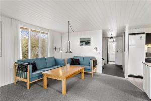 a living room with a blue couch and a table at LF593-Vestervig-Ingeborgs-Alle-21 in Vestervig +15 photos