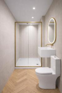 a bathroom with a shower and a toilet and a sink at The Bridge York in York