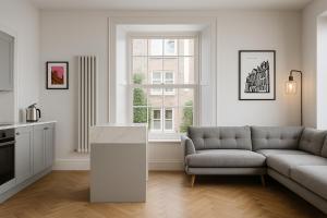 a living room with a couch and a window at The Bridge York in York